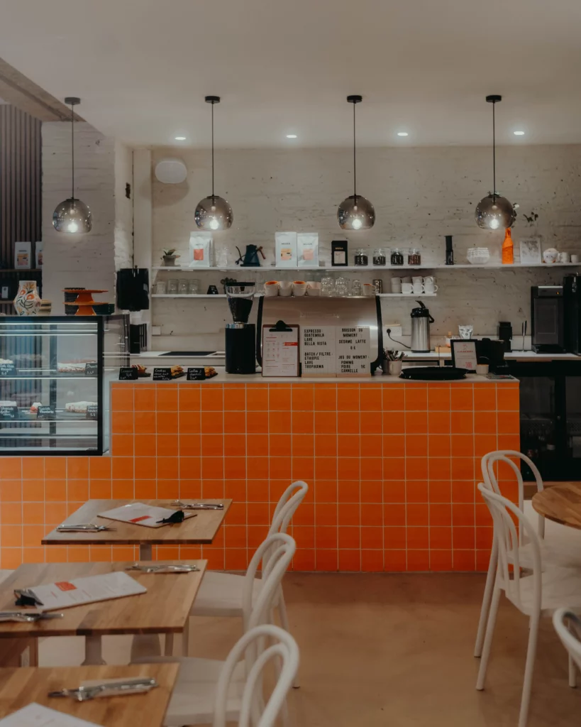 un comptoir orange de coffee shop à Toulouse avec du café de spécialité et des pâtisseries